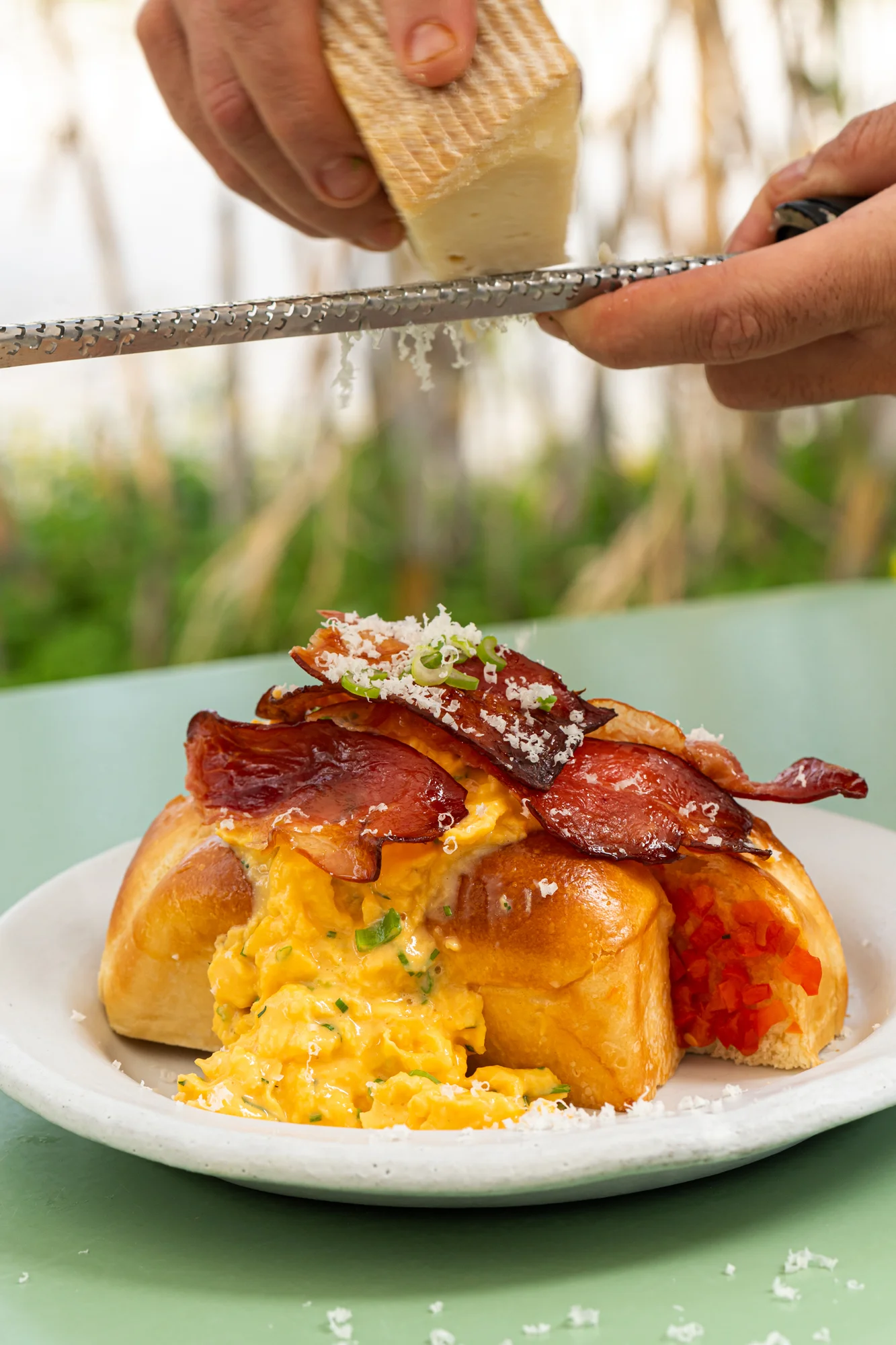 grating parmesan over brunch